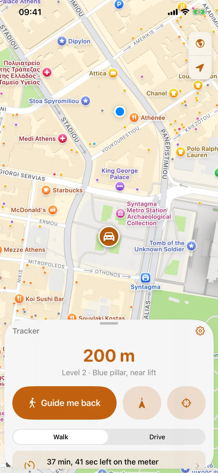The Tracker map screen. A pin marks the car in Athens, and the panel below reads 200 metres, Level 2, blue pillar near lift, with a Guide me back button.